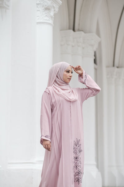 Close up of Muslimah Model wearing modest nidha abaya in pink with floral, pleated details on sleeves and hem