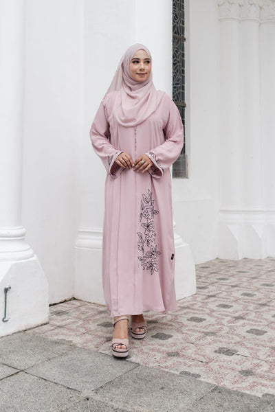 Muslimah Model wearing modest nidha abaya in pink with floral, pleated details on sleeves and hem