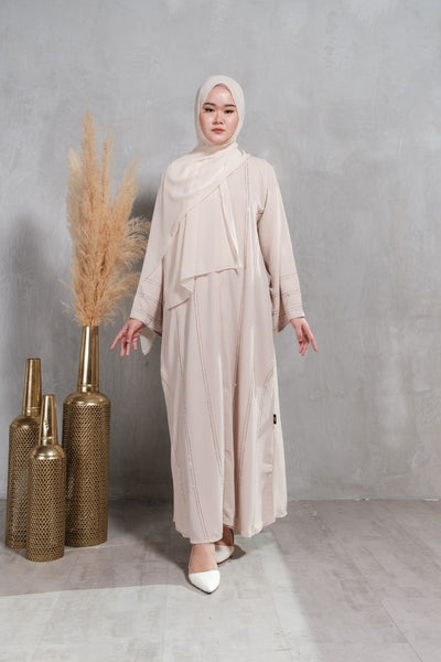 Muslimah Model in Korean nidha abaya with ombre thread and minimal crystal embellishments in cream.