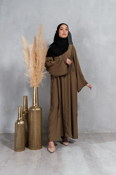  Muslimah Model wearing modest Korean nidha abaya in olive with crystal and embroidery detail.